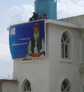 Gunman stand guard atop the mosque in which Sayyaf's rally was held. (c) Human Rights Watch
