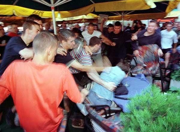 6.An anti-gay nationalist mob beats a gay activist during the first attempt to hold Gay Pride in Belgrade, Serbia, June 30 © 2001 Reuters Limited.

