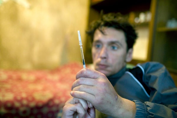 At home, a drug user prepares to inject heroin. &copy; 2007 Lorena Ros
