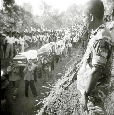 The LTTE continues to target civilians, murder perceived political opponents and forcibly recruited ethnic Tamils into its forces, many of them children. Here mourners bury the victims of the LTTE's June 15, 2006 landmine attack on a civilian bus, which killed 67. © 2006 Q. Sakamaki/Redux 
