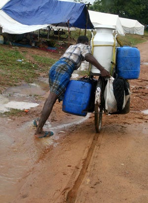 Some 315,000 people, mostly Tamils and Muslims, have had to flee their homes due to fighting since August 2006. This man pushes water in the Alamkalam camp for the displaced in Batticaloa district in February 2007.© 2007 Fred Abrahams/Human Rights Watch