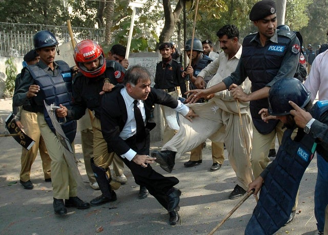 Policemen beat a lawyer outside provincial high court in Lahore on 

November 5, 2007. 
© 2007 Reuters

