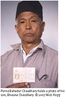 Text Box: 
Purna Bahadur Chaudhary holds a photo of his son, Bhauna Chaudhary. © 2007 Nick Hogg





