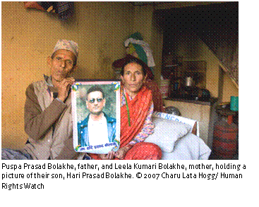 Text Box: 
Puspa Prasad Bolakhe, father, and Leela Kumari Bolakhe, mother, holding a picture of their son, Hari Prasad Bolakhe. © 2007 Charu Lata Hogg/ Human Rights Watch
