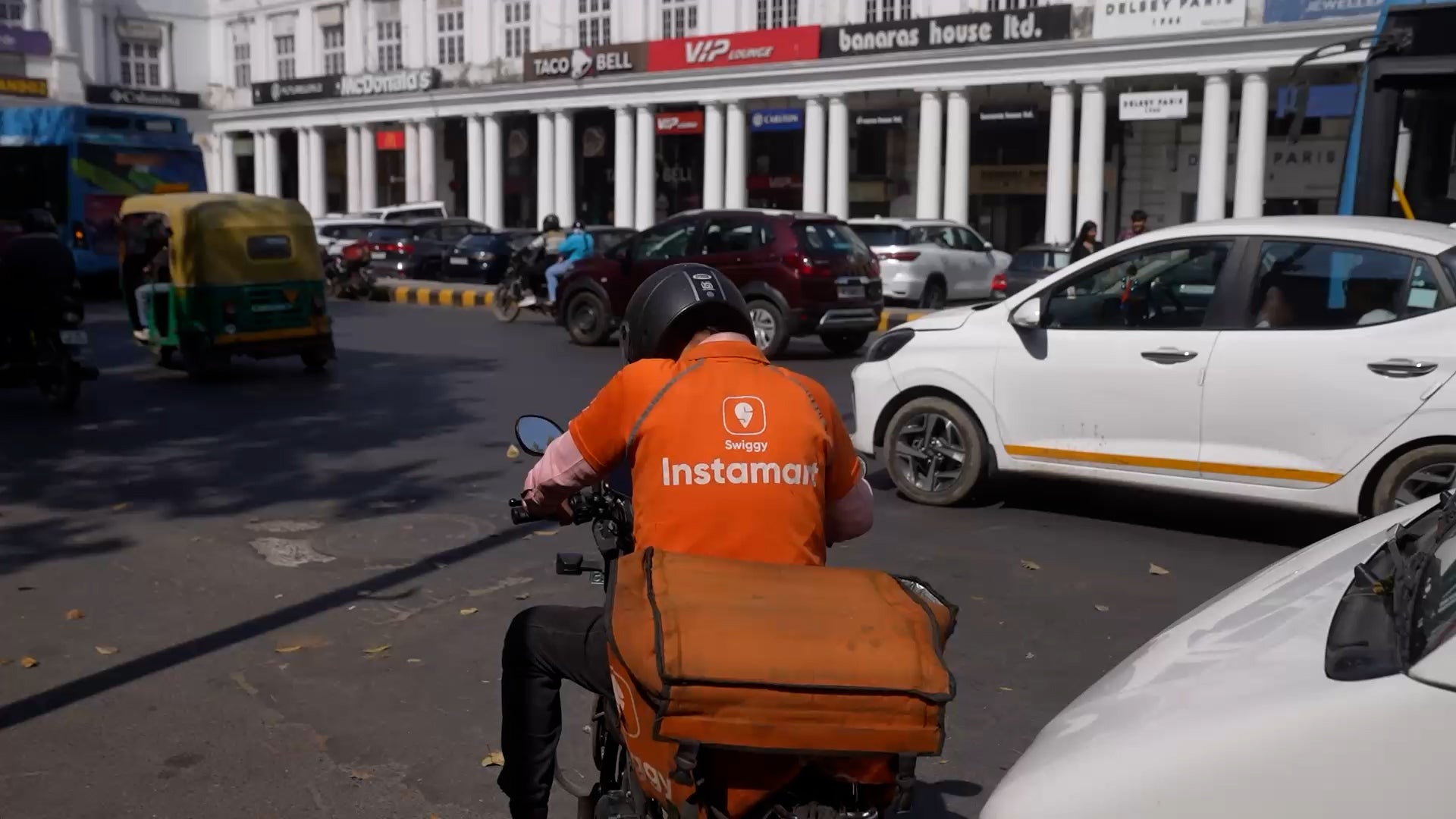 A delivery worker drives through New Delhi, India, 2026.
