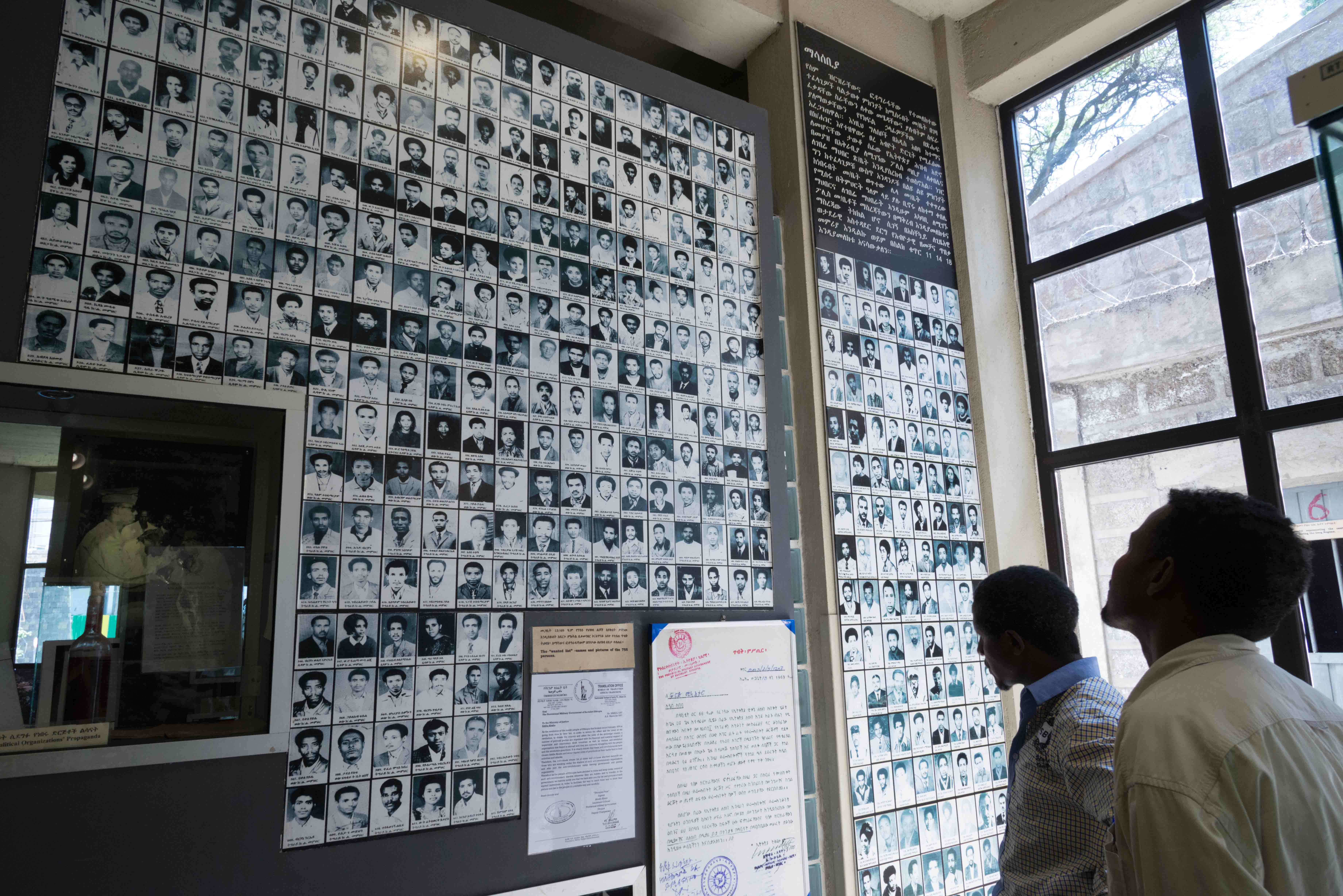 Visitors view photos of victims of the Derg regime in Ethiopia's Red Terror Martyrs' Memorial Museum in Addis Ababa on March 4, 2014. © 2014 Eitan Simanor/Alamy Stock Photo.  
