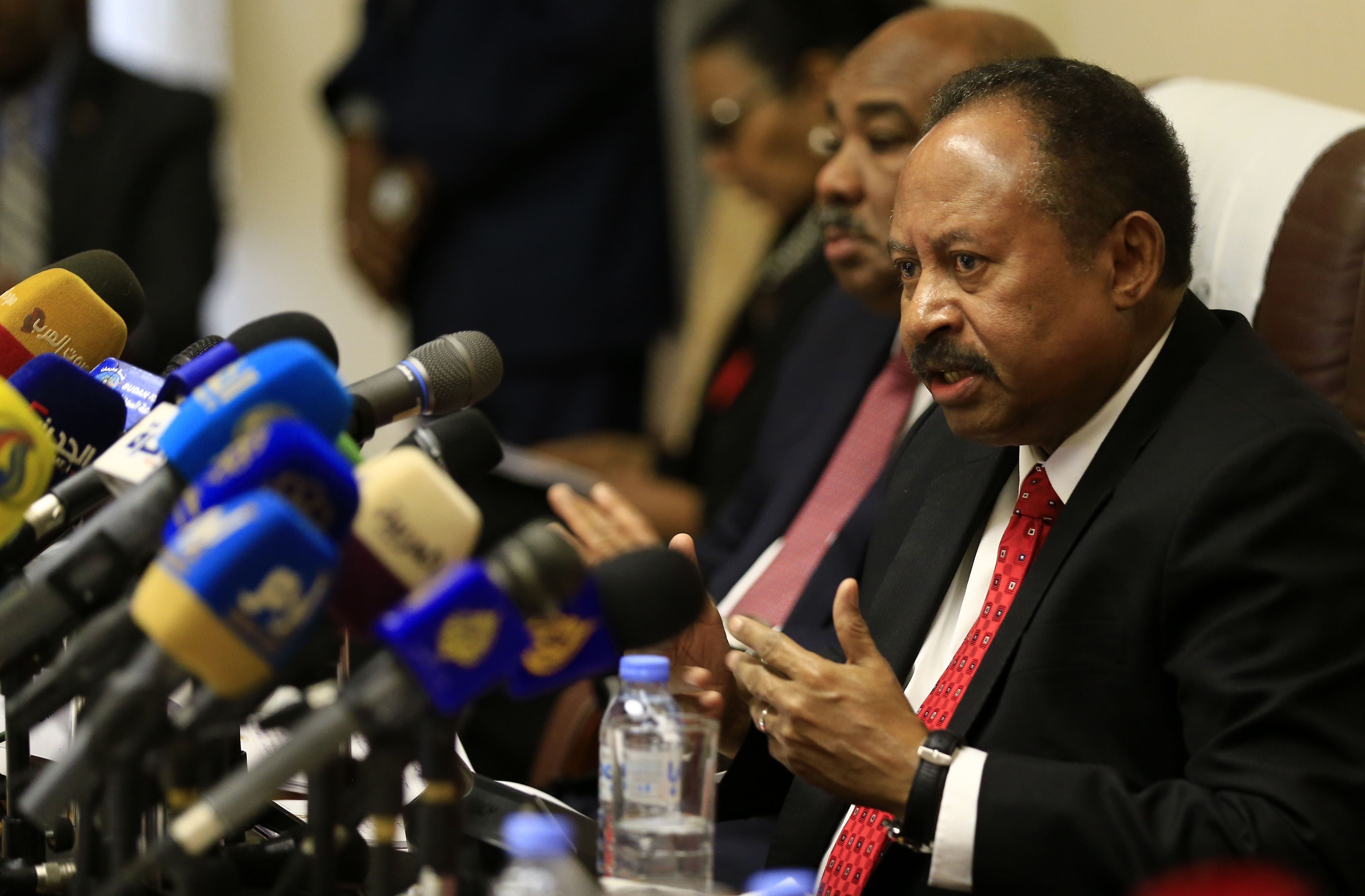 Sudanese Prime Minister Abdalla Hamdok (R) attends the opening session of the "Friends of Sudan" conference in the capital Khartoum on December 11, 2019.