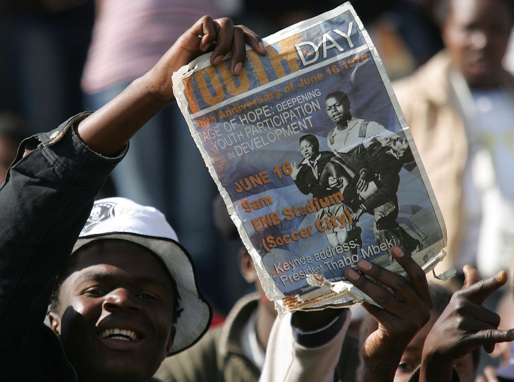 FILE: A South African youth holds a placard during the commemoration of the 30th anniversary of the uprisings in Soweto, South Africa, Friday, June 16, 2006.