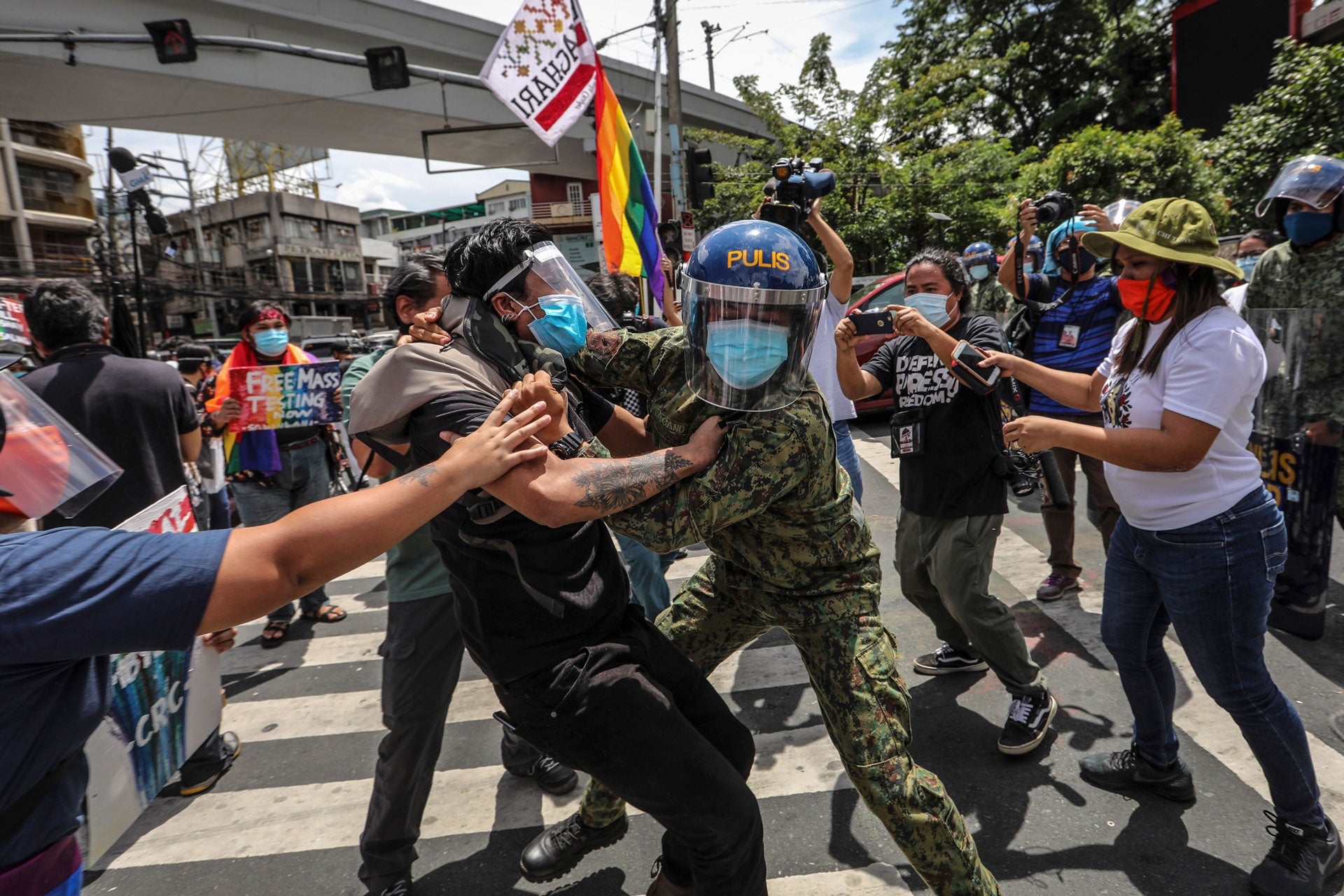 Police arrest protesters during a Pride march in Manila, Philippines, June 26, 2020.