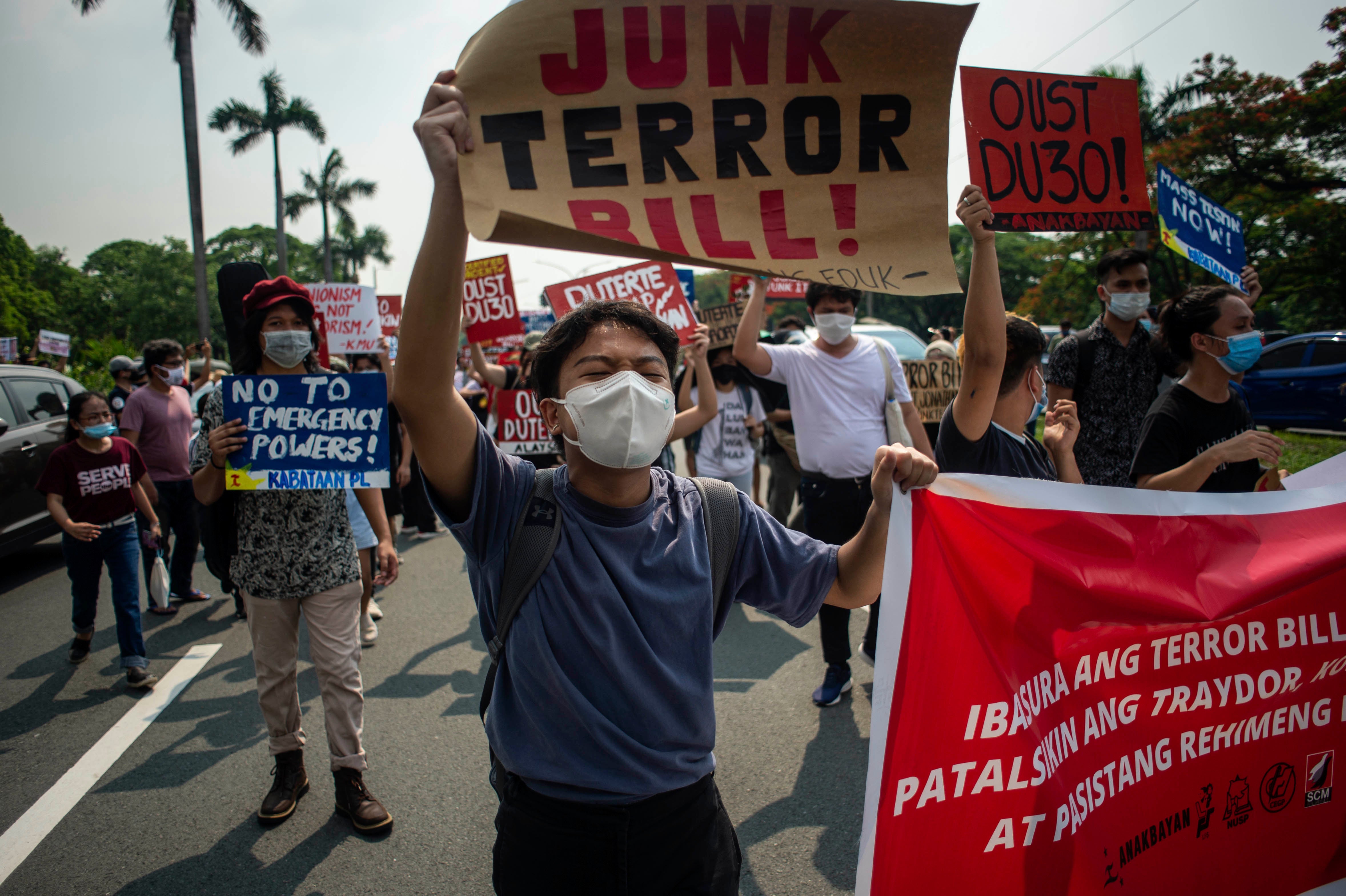 A protester carries a sign at a rally against the draft Anti-Terrorism Act in Quezon City, Philippines, June 4, 2020.