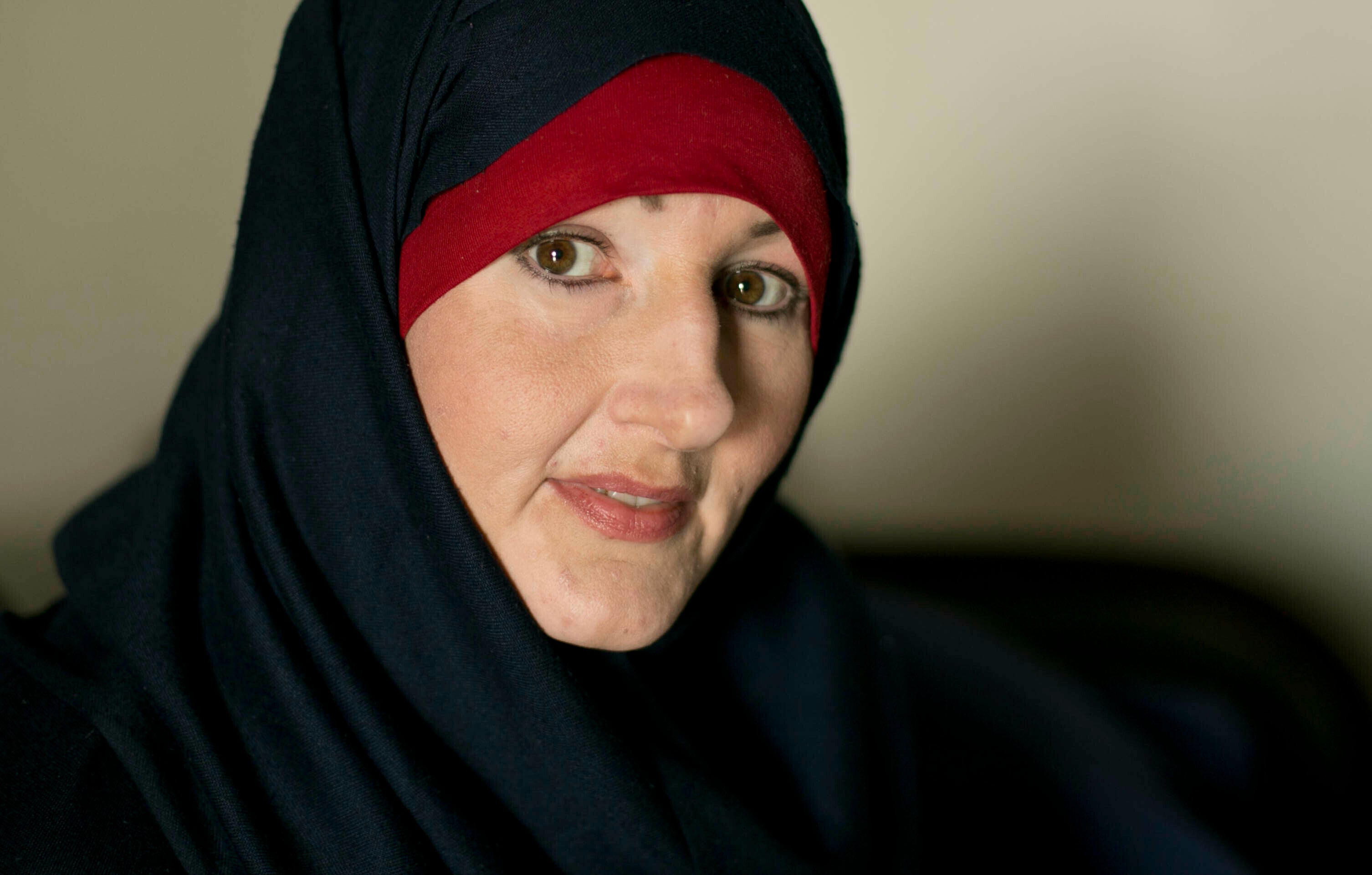 A woman poses wearing a hijab