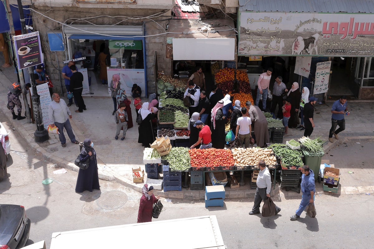  People shop for vegetables at the main market in Karak, Jordan, after a curfew was lifted for some southern cities, amid concerns about the coronavirus Wednesday, April 22, 2020.