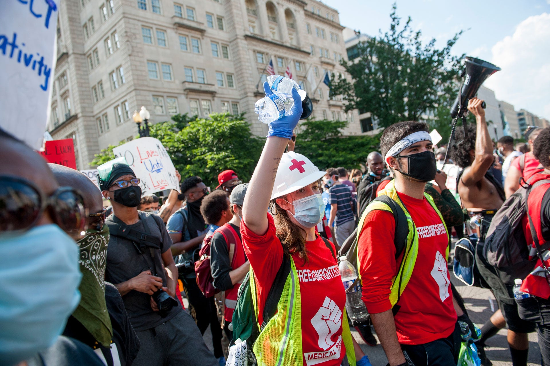 Medics and volunteers march with thousands of people gathered around Lafayette Square, in Washington, DC, to protest the death of George Floyd. [June?] 6, 2020.