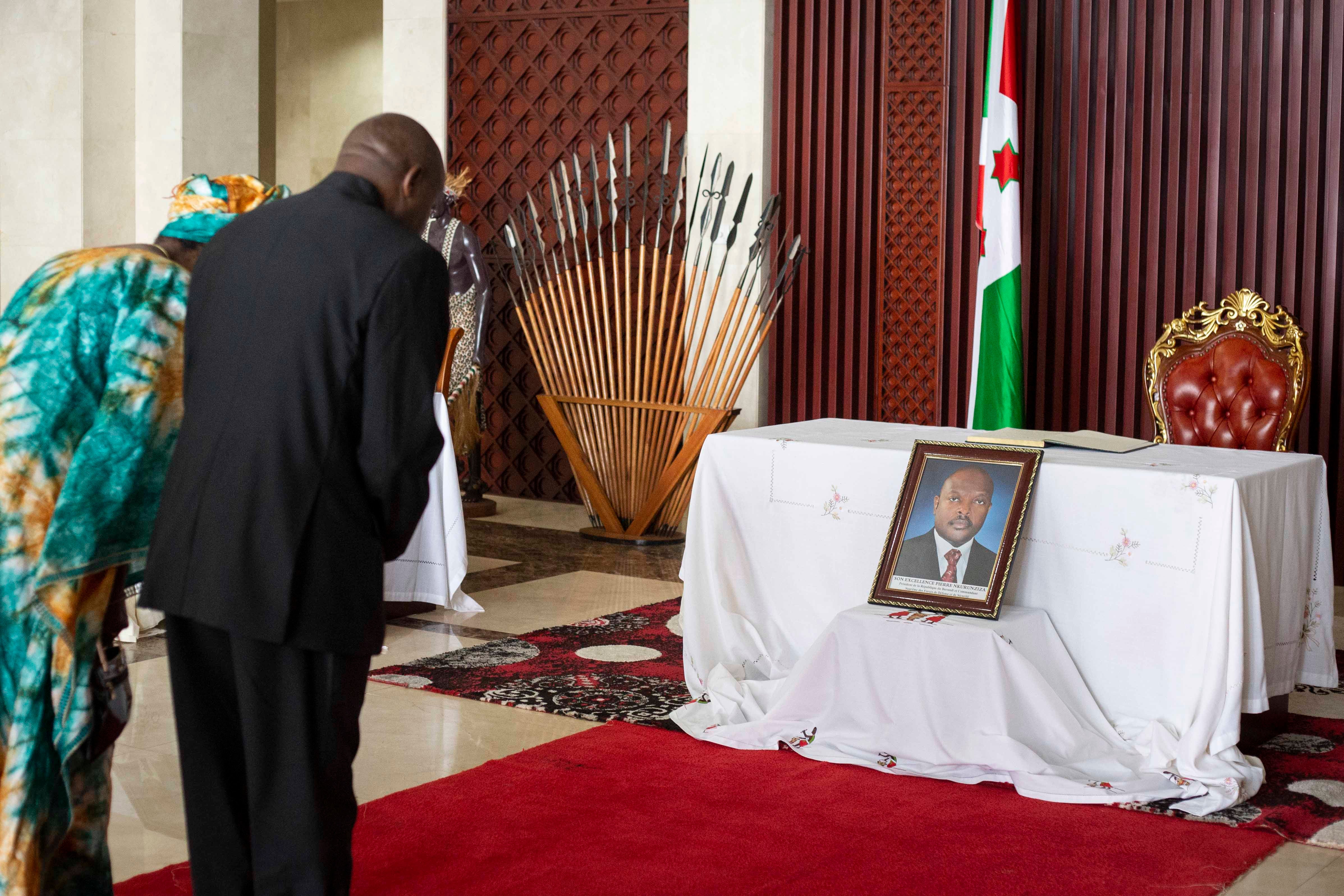 Burundi’s new president, Évariste Ndayishimiye, and his wife Angeline Ndayubaha pay their respects in front of a photograph of the late President Pierre Nkurunziza, at the presidential palace in Bujumbura, Burundi, on June 13, 2020.