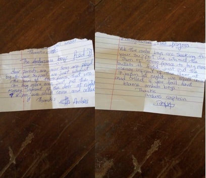 Two handwritten notes dropped at homes in Mamfe town, South-West region, in July, asking residents to contribute 15,000 XAF [USD 26] to the Red Dragons, an armed separatist group, so they can buy weapons and ammunition. ©Private