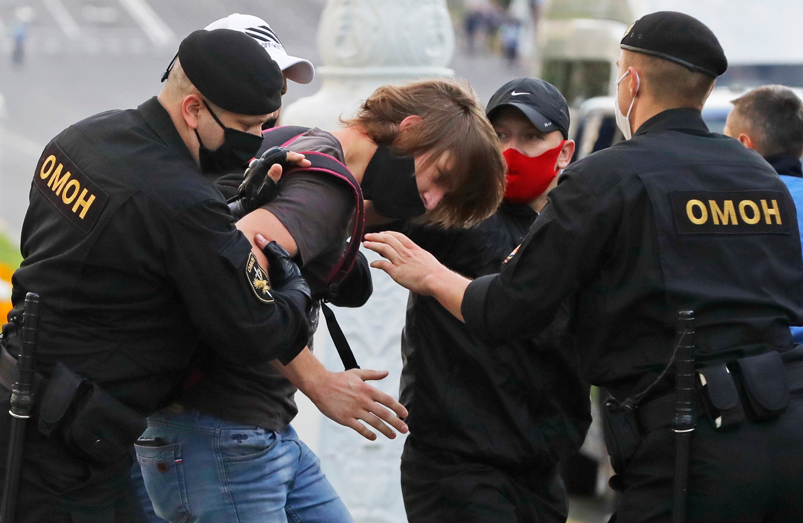 Police officers detain a protester in Minsk, Belarus, on July 14, 2020 during a protest rally against a decision to bar a number of opposition candidates from running in the presidential elections on August 9.