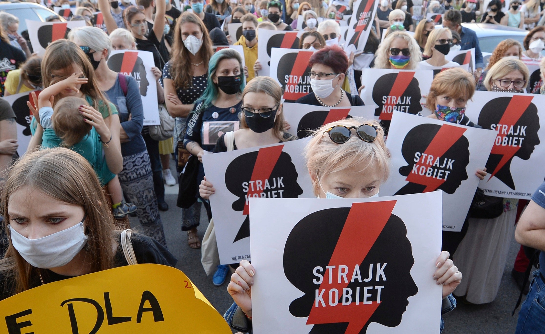 Protesters with a banner reading "Women's Strike" take part in a rally against the Polish government’s plans to withdraw from the Istanbul Convention on prevention and combating of domestic violence, in Warsaw, Poland, July 24, 2020. © 2020 AP Photo/Czarek Sokolowski