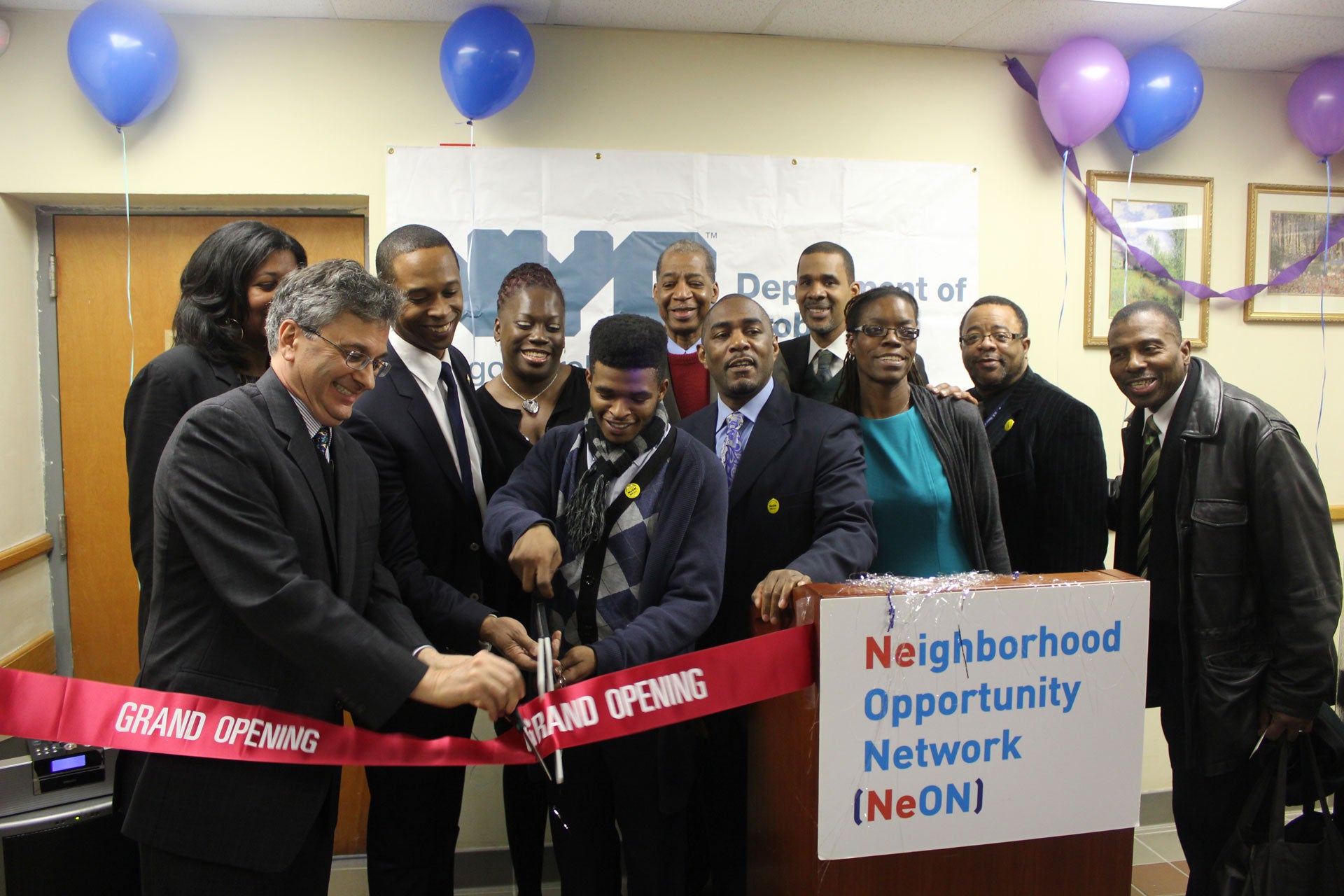 Former Commissioner Vincent Schiraldi and others cut a ribbon at the opening of the Neighborhood Opportunity Network at the New York City Department of Probation. 
