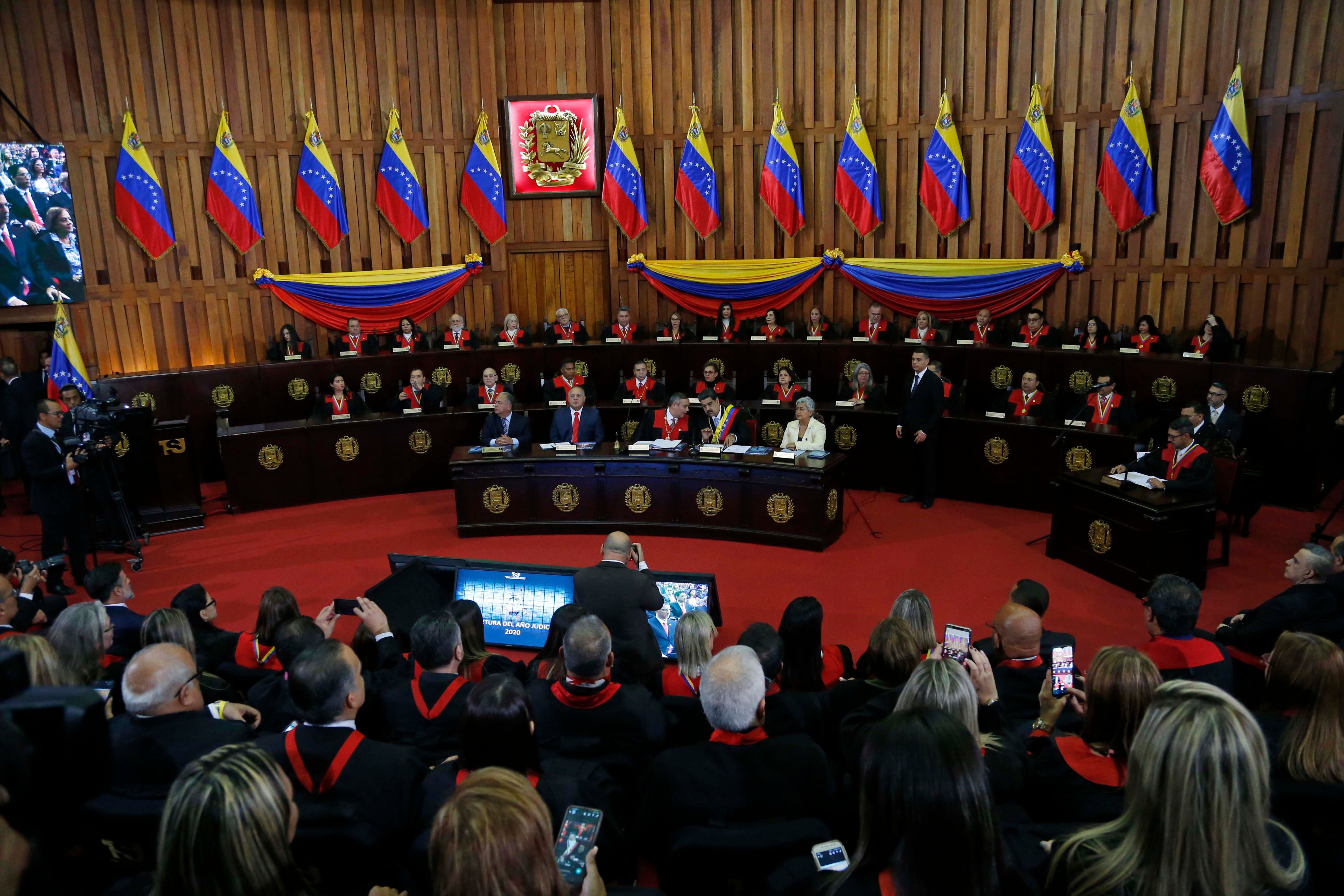 Nicolas Maduro, sitting at desk second from right, speaks with Supreme Court President Maikel Moreno at the Supreme Court before giving his annual presidential address in Caracas, Venezuela. January 31, 2020. 