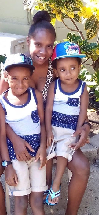 Charlie Gowa (left), his mother Xernona PoiPoi, and brother Richard.