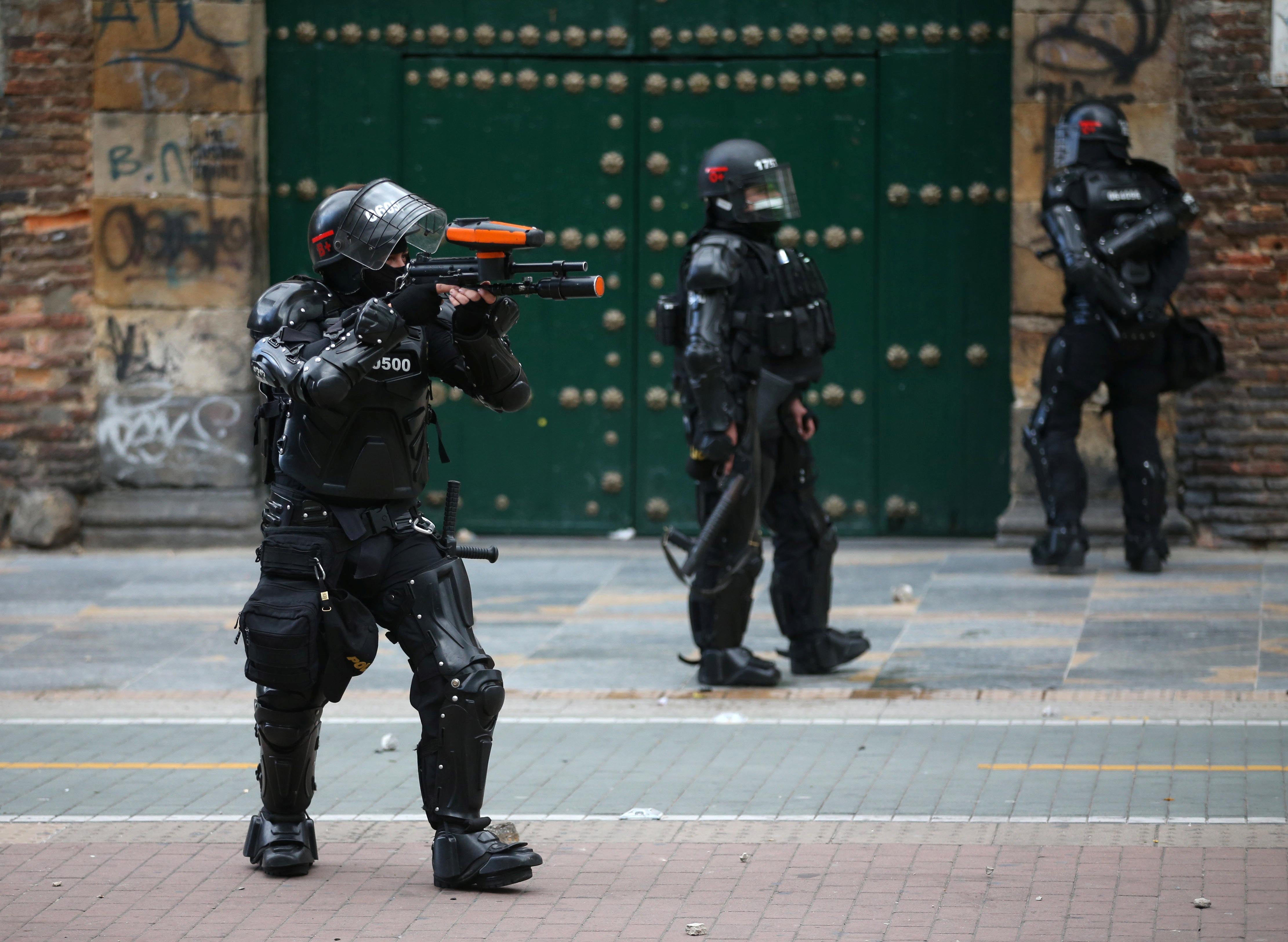 A member of the security forces aims during a demonstration against police brutality in Bogotá, Colombia, on September 13, 2020.