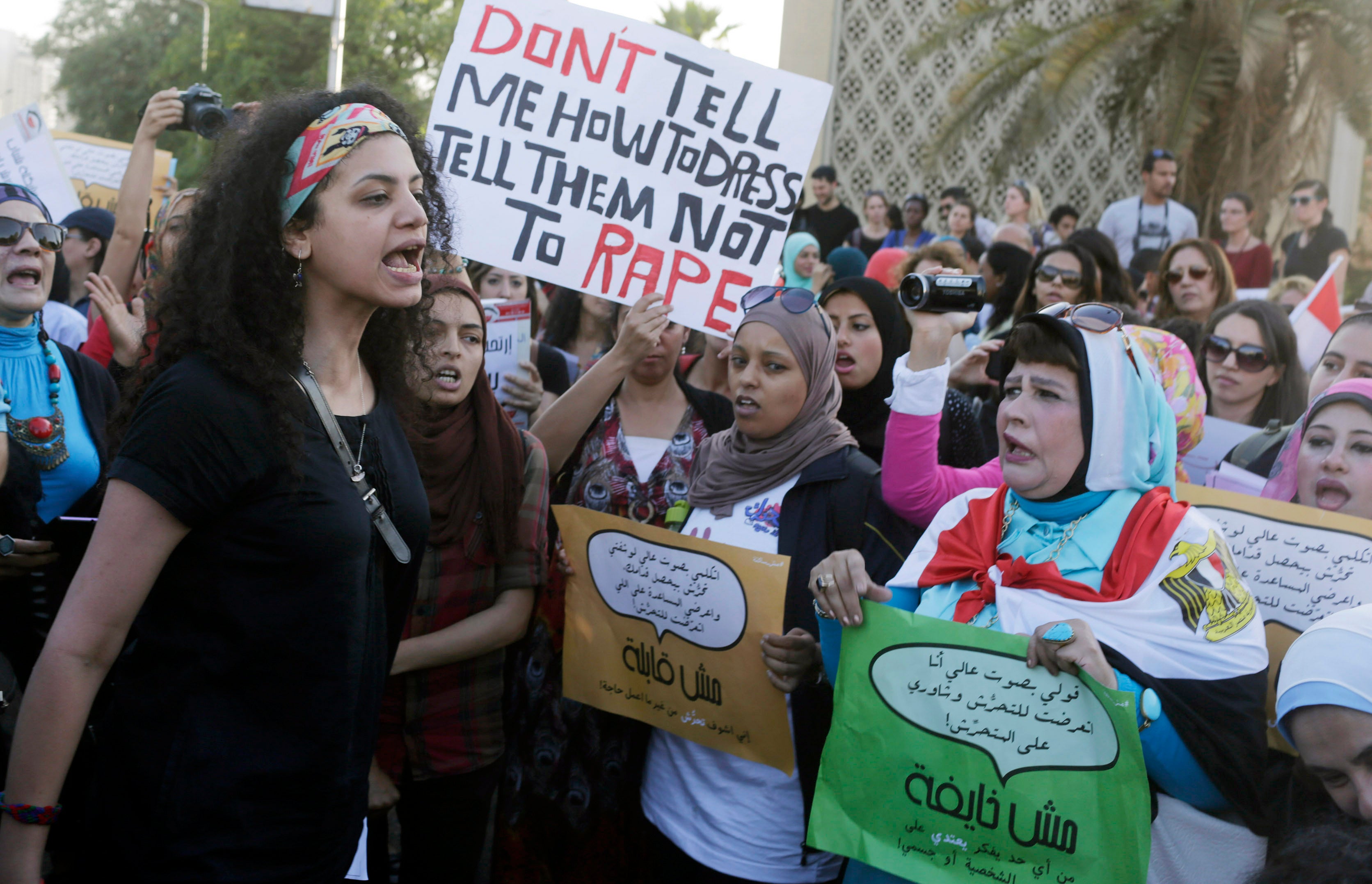 Women chant slogans as they gather to protest sexual harassment in front of the opera house in Cairo on June 14, 2014. 