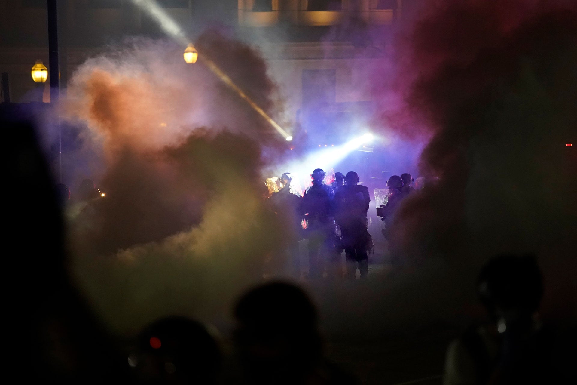 Police in riot gear clear the area in front of Kenosha County Courthouse during clashes with protesters in Kenosha, Wisconsin, August 25, 2020.