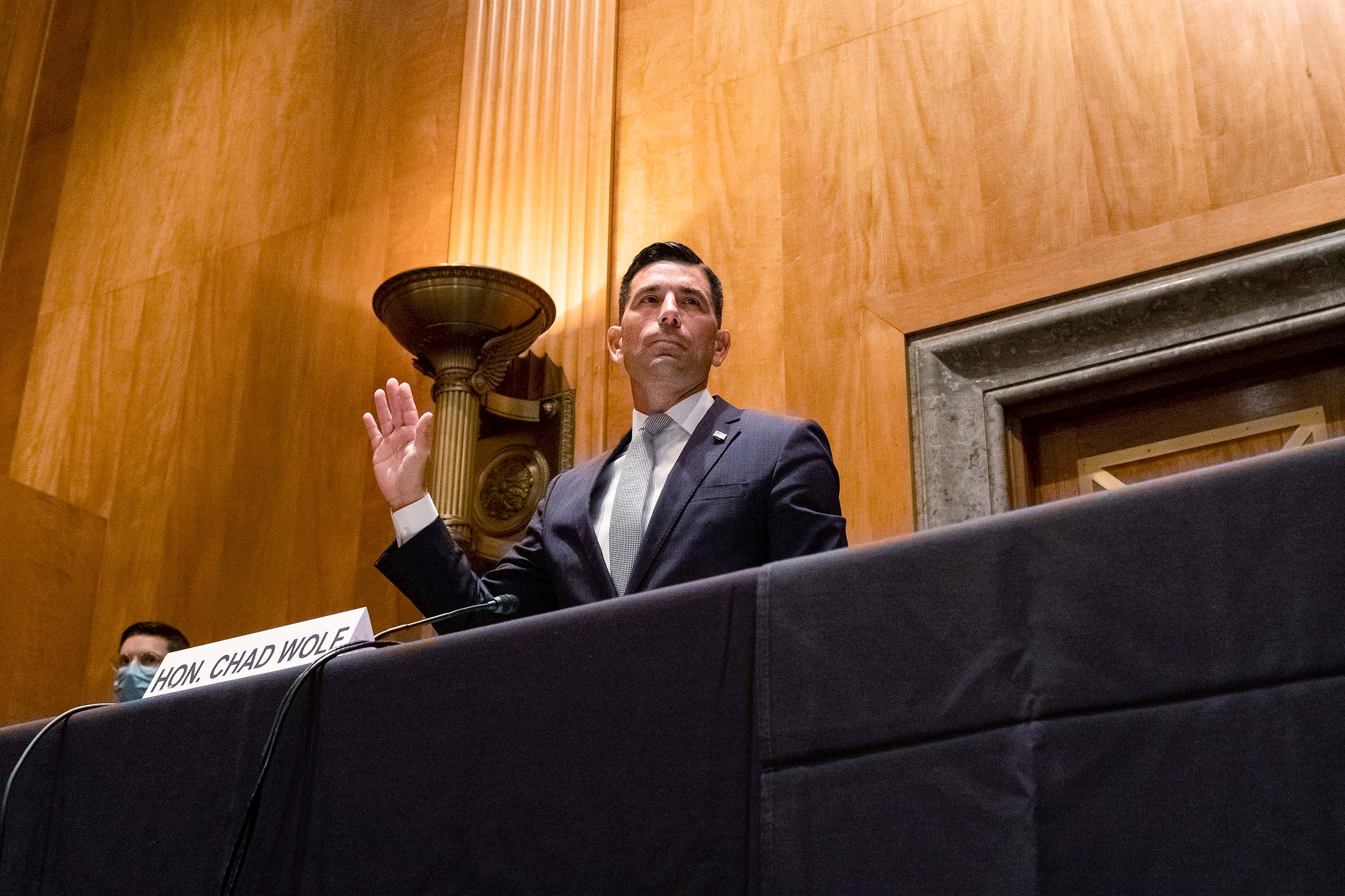 The acting secretary of the US Department of Homeland Security, Chad Wolf, raises his right hand to swear in during a Senate Homeland Security and Governmental Affairs Committee confirmation hearing on September 23, 2020 in Washington, DC.