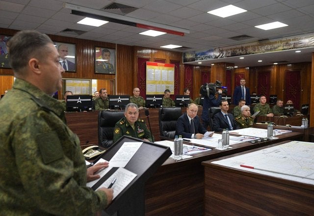 A man in military uniform speaks at a meeting