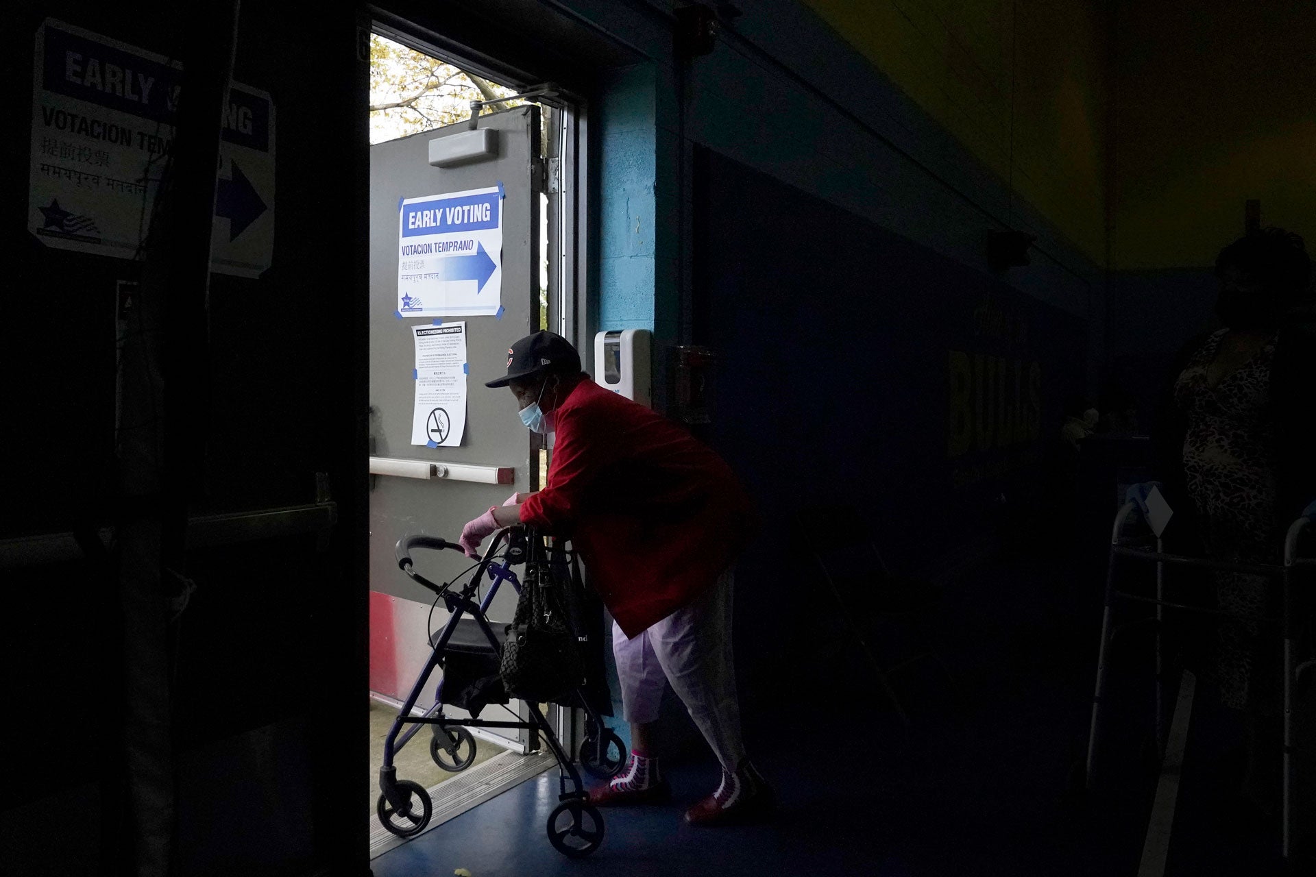 A woman departs the Beethoven Elementary School after participating in early voting in Chicago, October 15, 2020. 