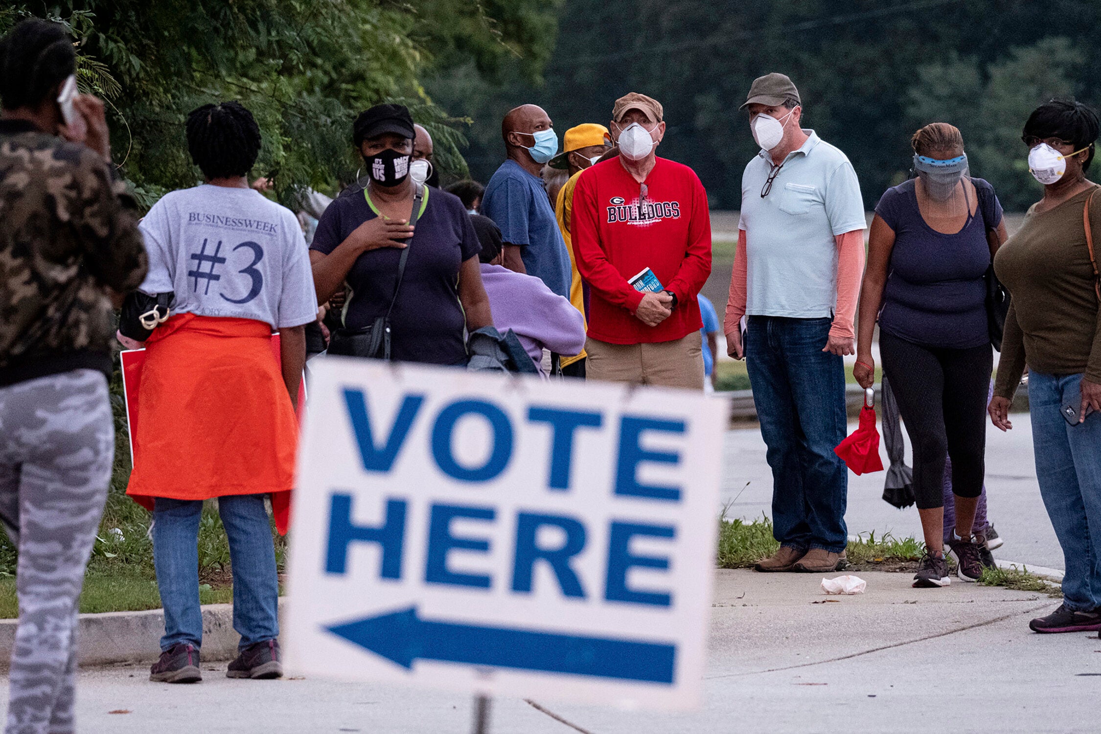 People wait in line to vote in Decatur, Ga., Monday, Oct. 12, 2020