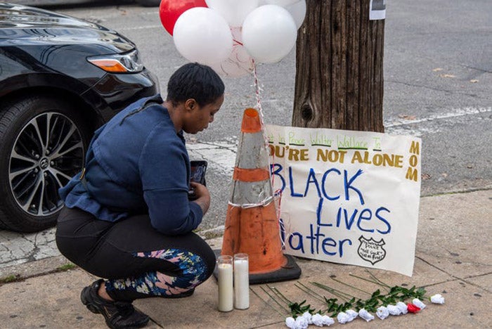 A neighbor gathers at a memorial outside Walter Wallace Jr.'s home in Philadelphia, Pennsylvania, October 27, 2020.