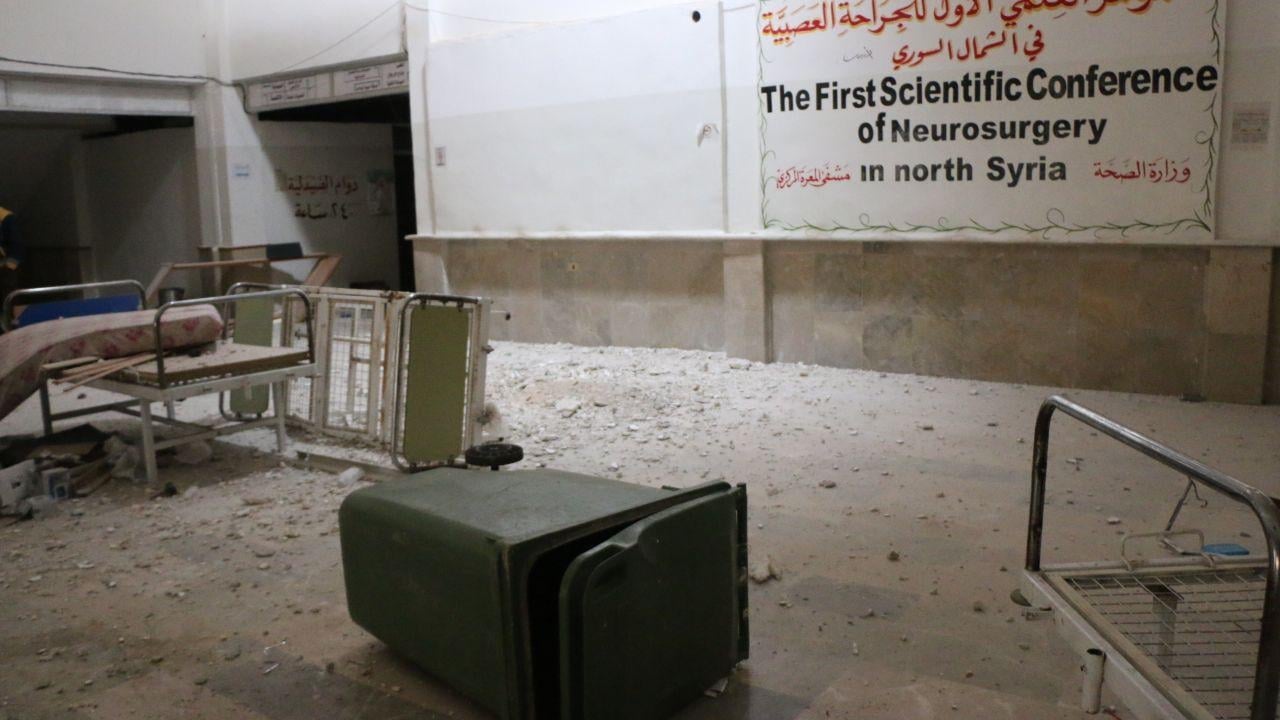 Overturned furniture and rubble in an empty hospital room