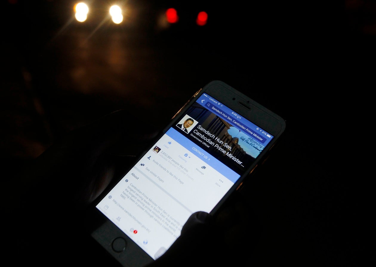 A man views Cambodian Prime Minister Hun Sen's Facebook page on his mobile phone in downtown Phnom Penh, Cambodia.