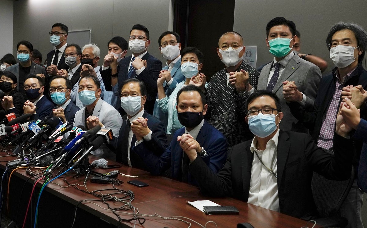 Hong Kong's pro-democracy legislators pose for a photo before a press conference at Legislative Council in Hong Kong, Wednesday, Nov. 11, 2020. 