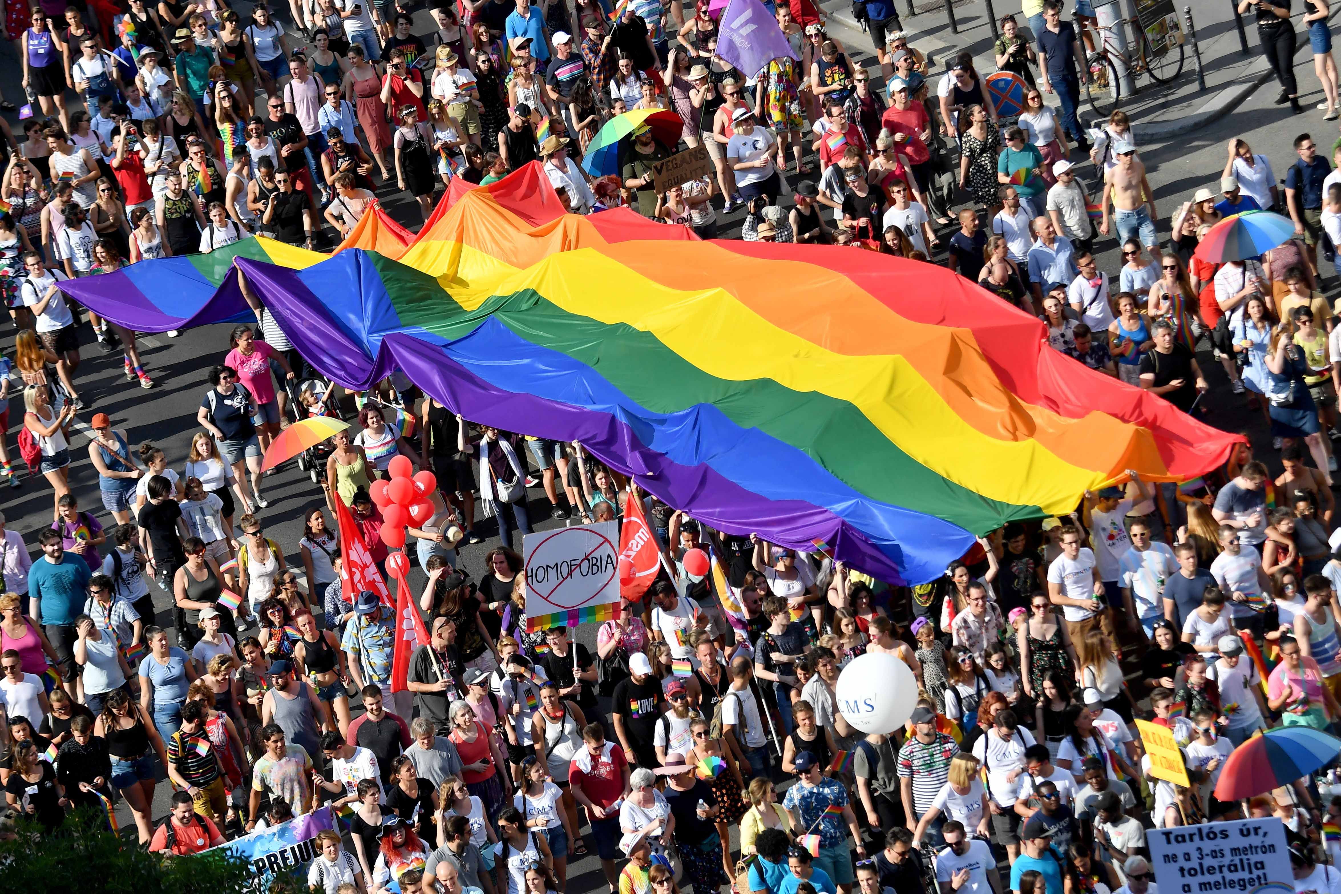 People march with a giant rainbow flag from the parliament building in Budapest during the lesbian, gay, bisexual and transgender (LGBT) Pride Parade on July 6, 2019.