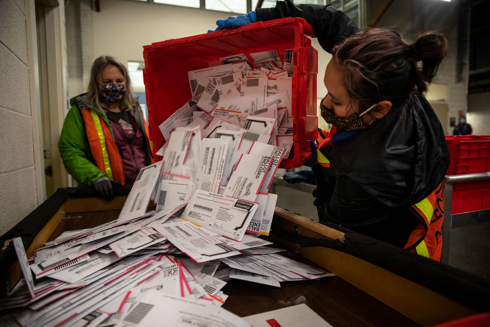 Election workers empty ballots at the Multnomah County Elections Division in Portland, Oregon, November 3, 2020. 