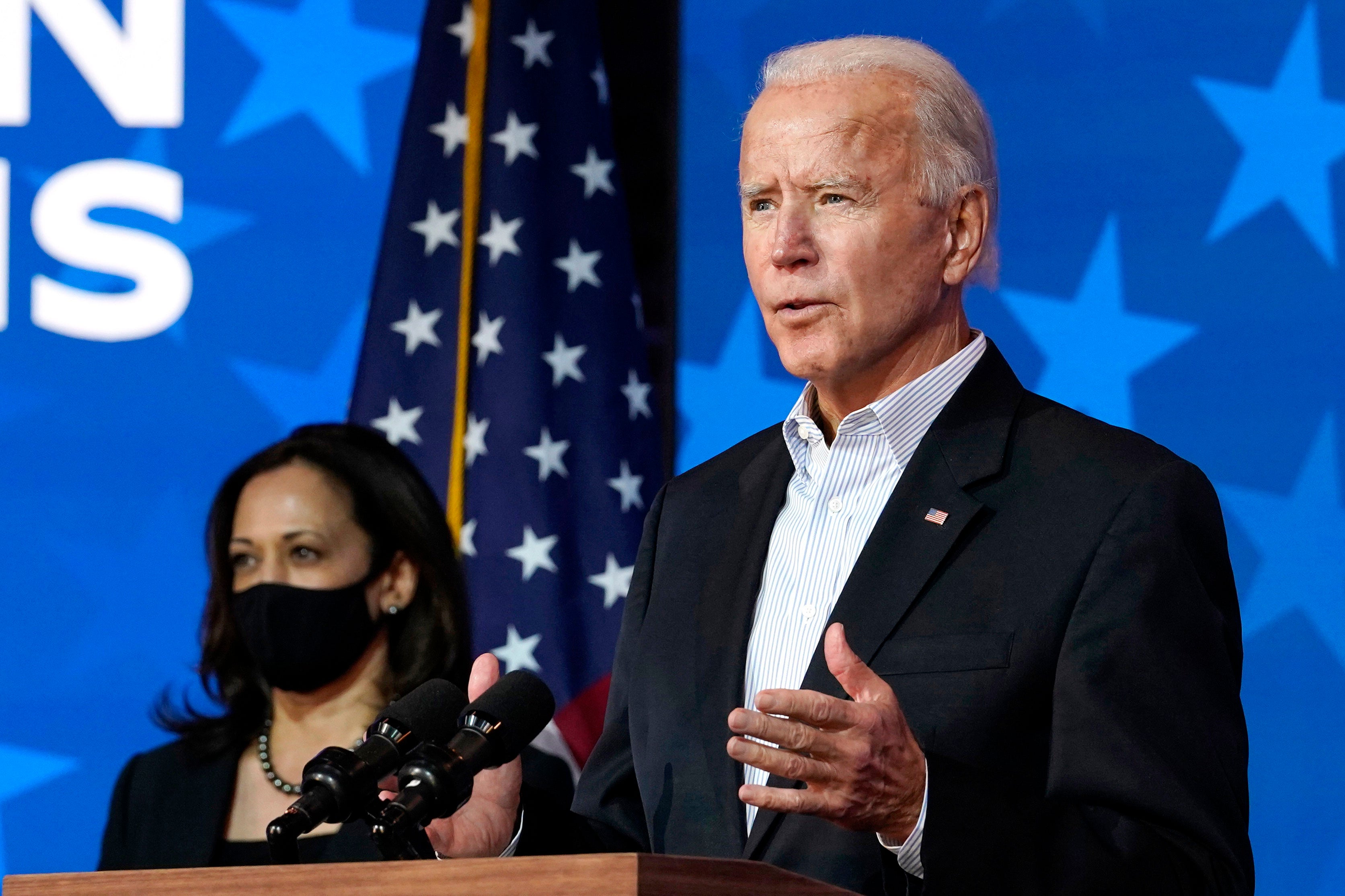 Joe Biden speaks in Wilmington, Delaware on November 5, 2020, while Kamala Harris looks on.  