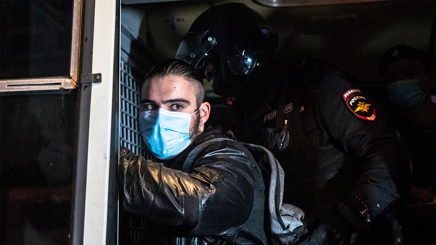 A police officer pats down a protester detained during a rally calling for the results of a referendum on Constitutional amendments to be cancelled in Moscow, Russia, Wednesday, July 15, 2020.