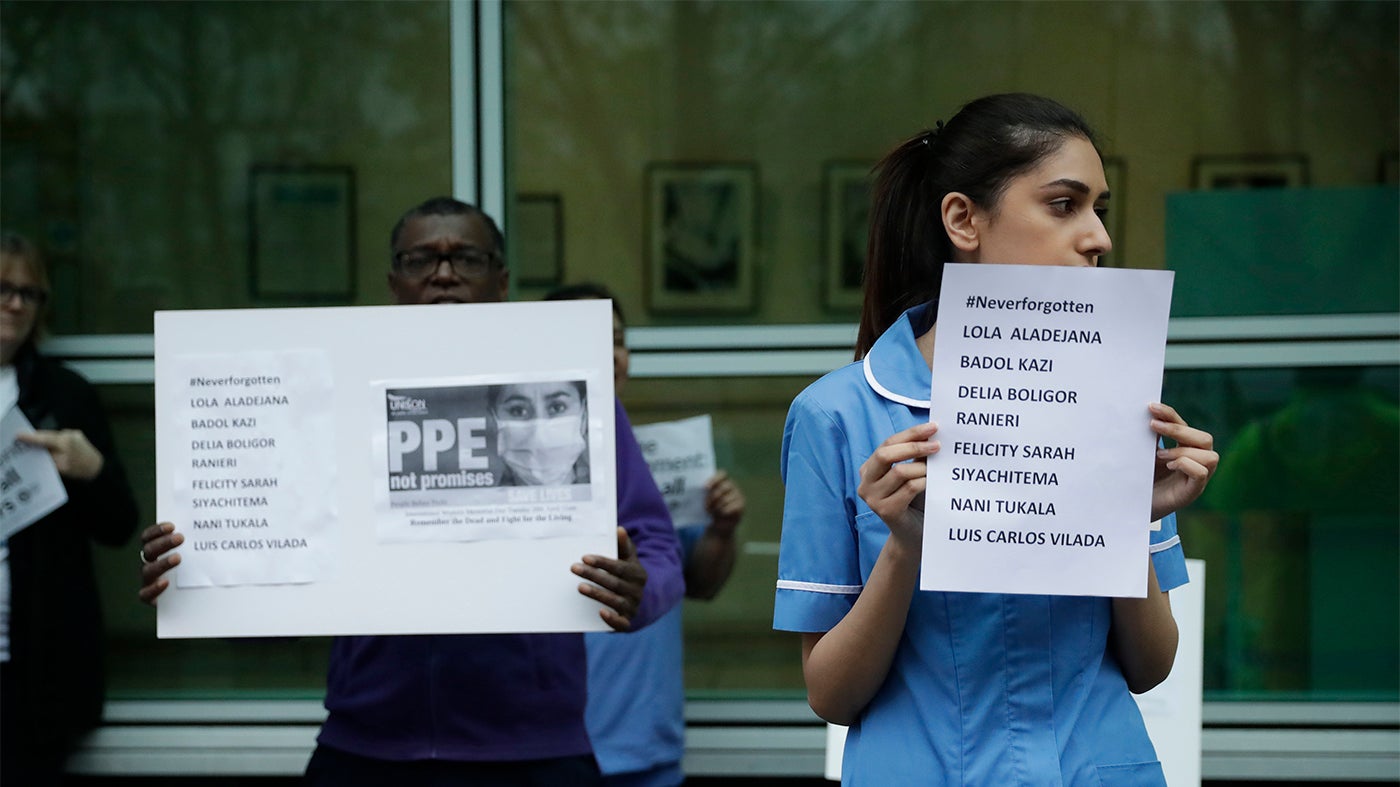 Hospital workers remember their colleagues who have died from coronavirus and call on UK health authorities to provide personal protective equipment at University College Hospital in London, April 2020.
