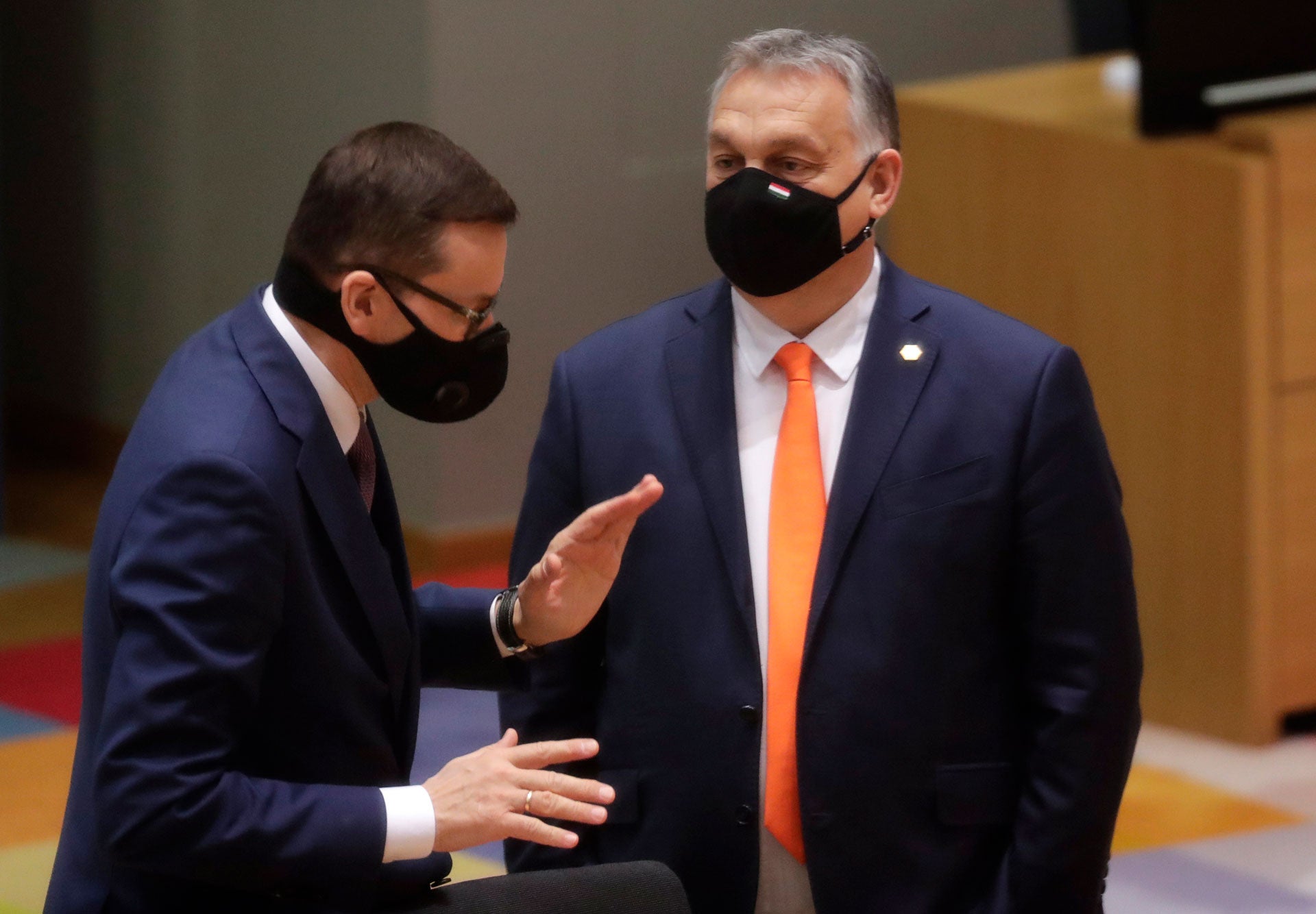 Poland's Prime Minister Mateusz Morawiecki, left, speaks with Hungary's Prime Minister Viktor Orban during a round table meeting at an EU summit at the European Council building in Brussels, December 10, 2020. 