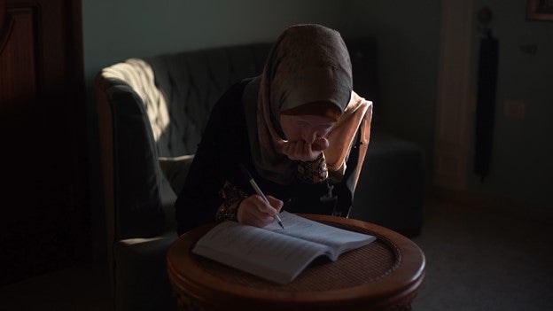 Eman AbuJarad, a 21-year-old woman with low vision, tries to study during a power outage in Gaza . “When electricity cuts off in evening hours and then comes back, it takes me an hour to regain my sight,” she told Human Rights Watch. 