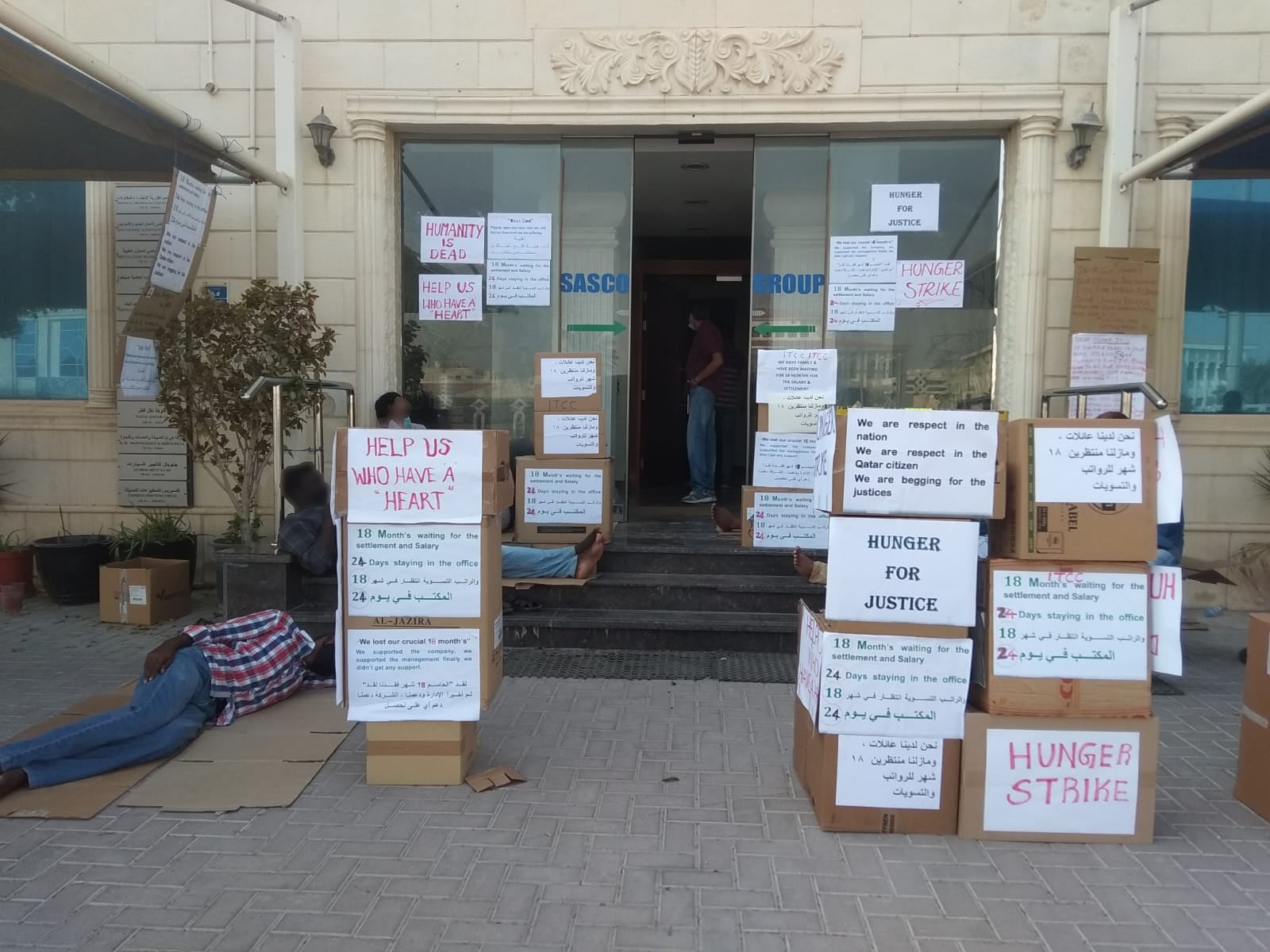 Former and current employees of Imperial Trading and Construction Company (ITCC) protest months of delayed and unpaid wages outside the company's headquarters. 