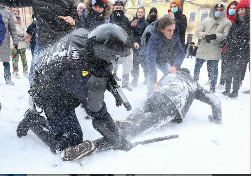 A policeman detains a man while protesters try to help him, during a protest against the jailing of opposition leader Alexei Navalny in St. Petersburg, Russia, Sunday, Jan. 31, 2021.