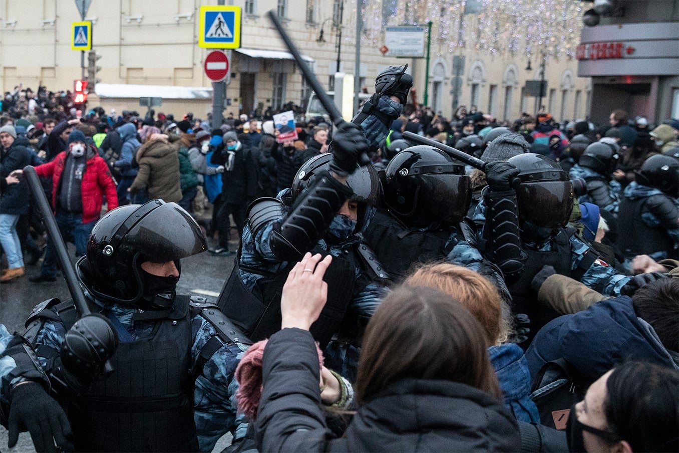 Police officers clash with people during a protest against the jailing of opposition leader Alexei Navalny in Moscow.