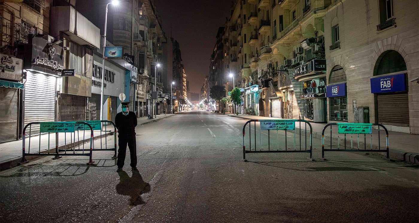 Egyptian security forces cordon off roads during curfew hours in Cairo, Egypt, Sunday, March 29, 2020