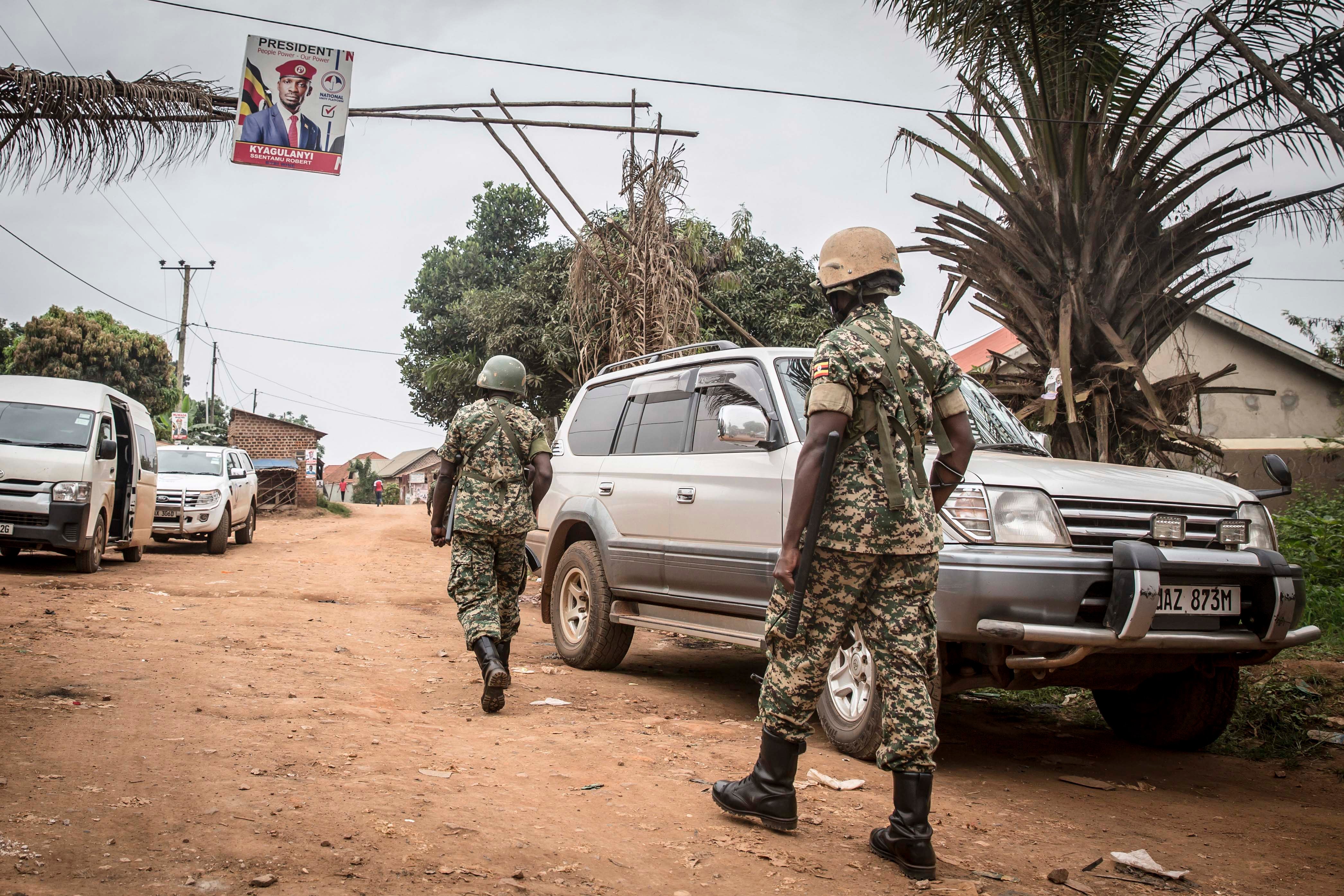 Ugandan soldiers patrol near the house of Ugandan opposition presidential candidate Robert Kyagulanyi, also known as Bobi Wine in Magere, Uganda. 
