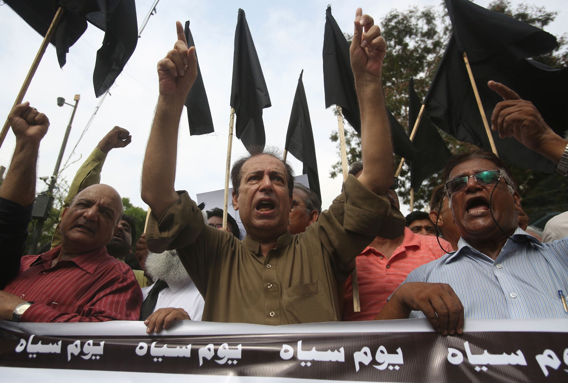 Pakistani journalists hold nationwide protests to denounce rampant censorship, and hold a banner that reads: "black day," in Karachi, Pakistan, July 16, 2019.