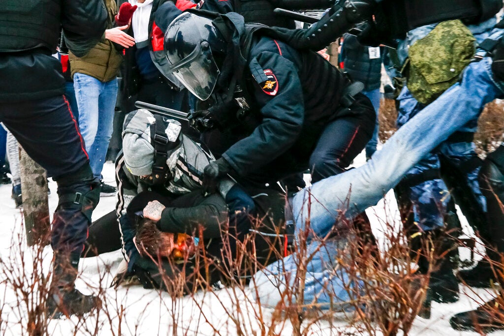 Riot police detain a demonstrator with a bloody face during a protest against the jailing of opposition leader Alexei Navalny in Pushkin Square, Moscow, Russia, Saturday, January 23, 2021. 