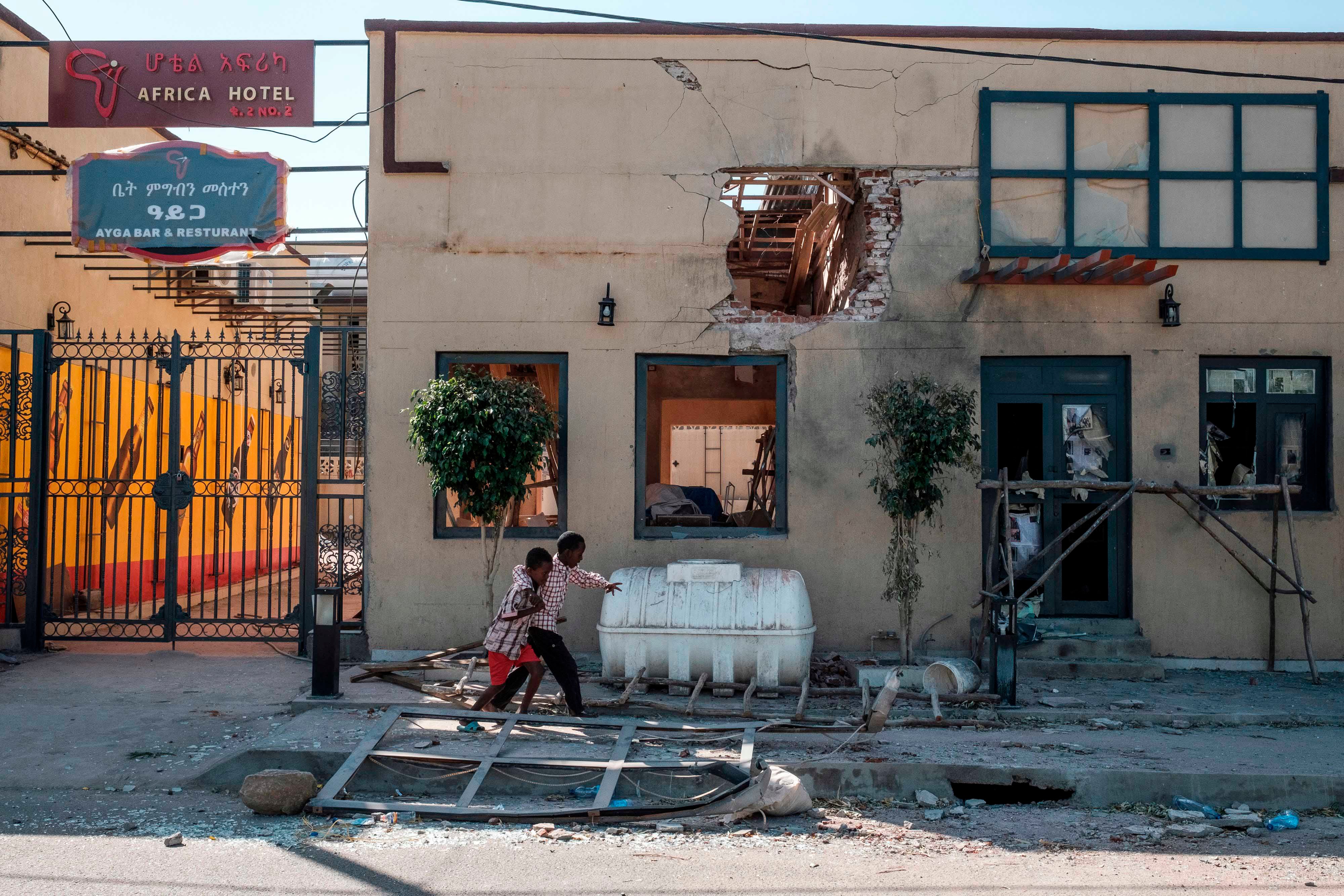 Children in front of the Africa/Ayga hotel likely damaged by a direct fire weapon in Humera town, Tigray region, Ethiopia, on November 22, 2020.